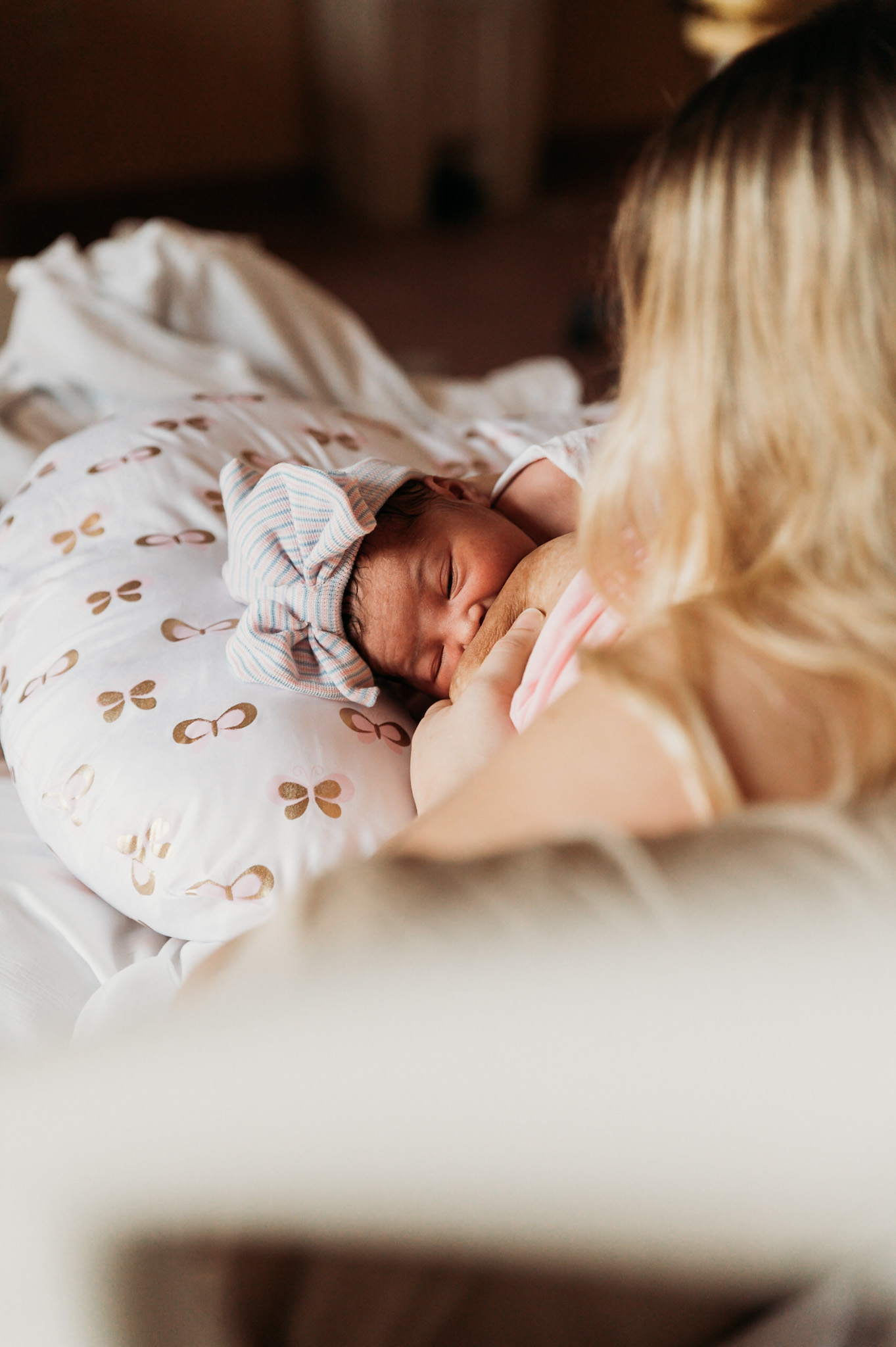 Mother breastfeeding her baby girl after delivery in HealthPark Medical Center in Fort Myers captured by Birth Photographer Ella Rae Photography